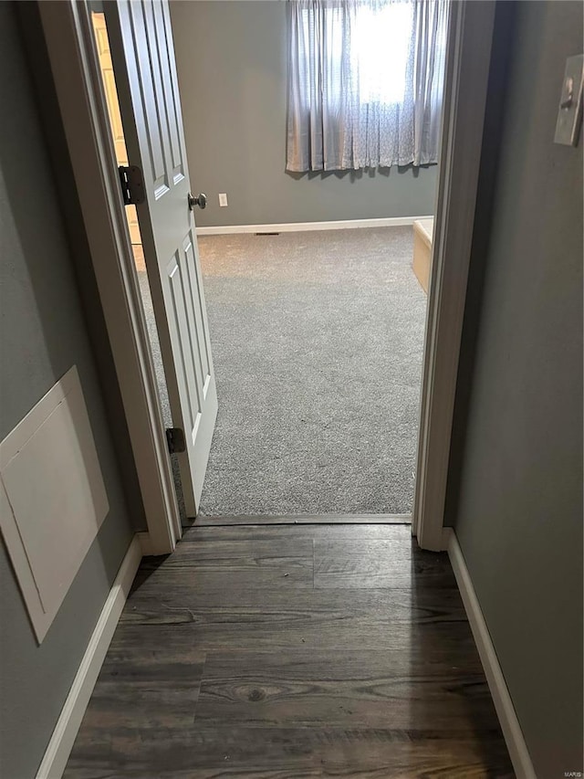 corridor with dark hardwood / wood-style floors