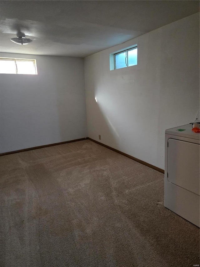 basement with washer / dryer, light colored carpet, and a wealth of natural light