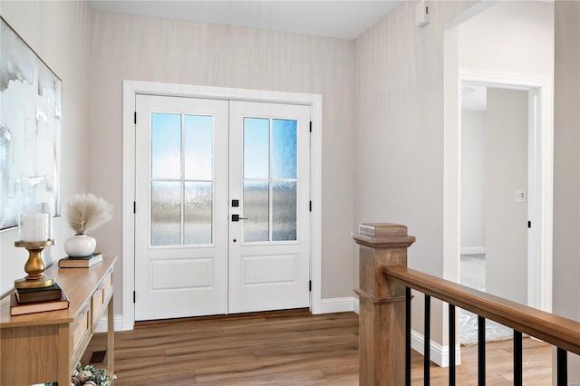 foyer featuring dark hardwood / wood-style floors and french doors