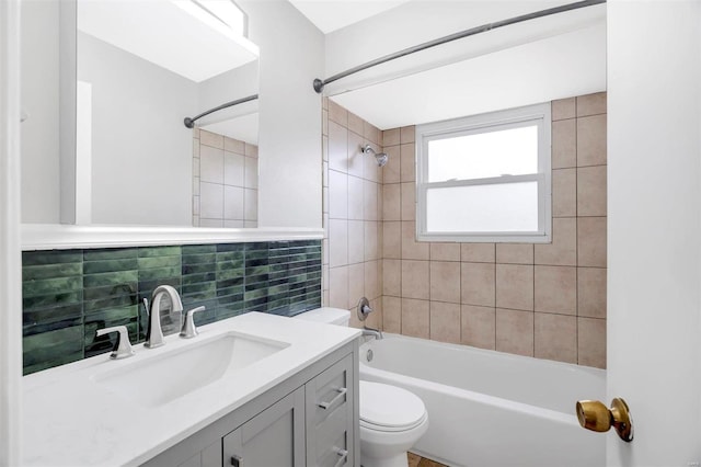 full bathroom featuring vanity, backsplash, toilet, and tiled shower / bath