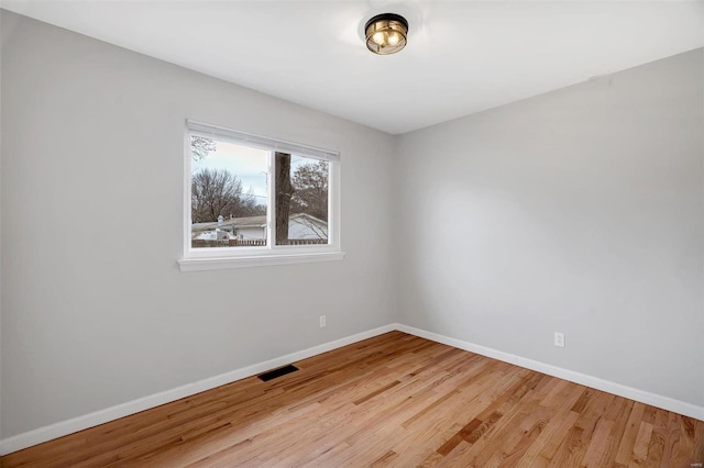 spare room with light hardwood / wood-style flooring