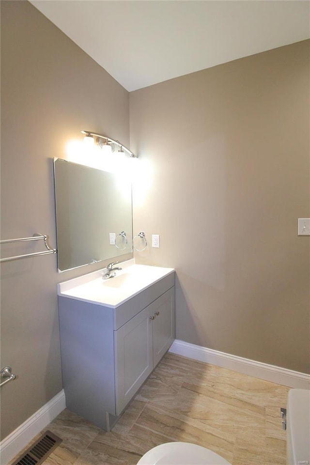 bathroom featuring hardwood / wood-style floors, vanity, and toilet