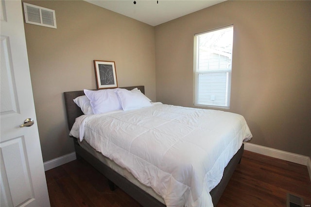 bedroom featuring dark hardwood / wood-style flooring