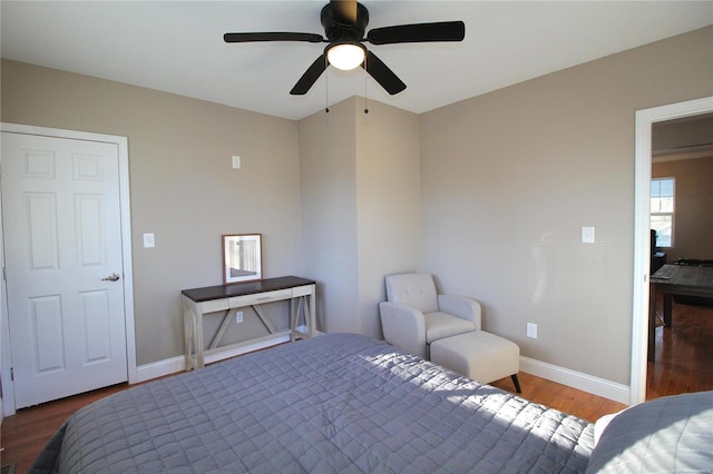 bedroom with ceiling fan and dark wood-type flooring