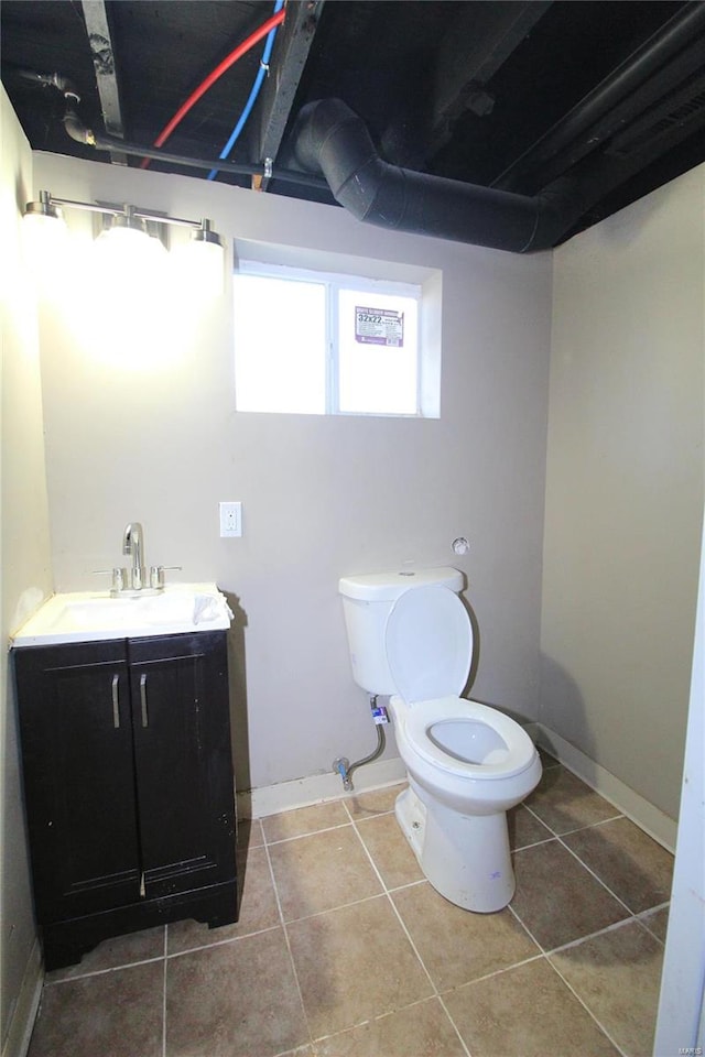 bathroom featuring tile patterned floors, vanity, and toilet