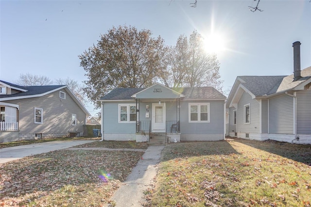 bungalow-style home with a front yard