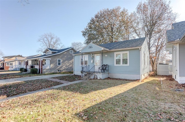 bungalow-style house featuring a front lawn