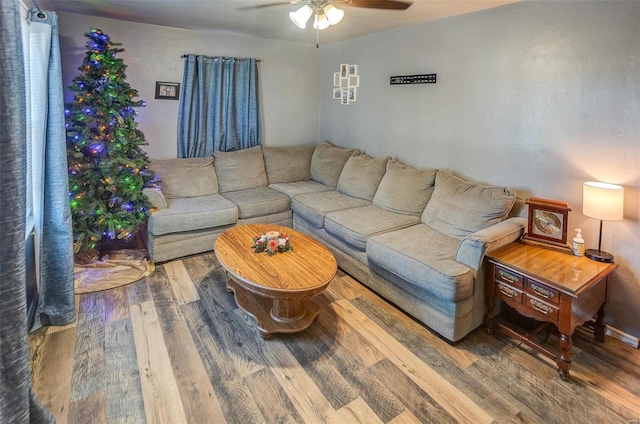 living room featuring hardwood / wood-style flooring and ceiling fan