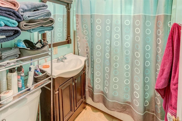 bathroom with tile patterned flooring, a shower with curtain, vanity, and toilet