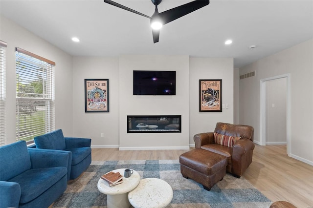 living room featuring ceiling fan and light wood-type flooring