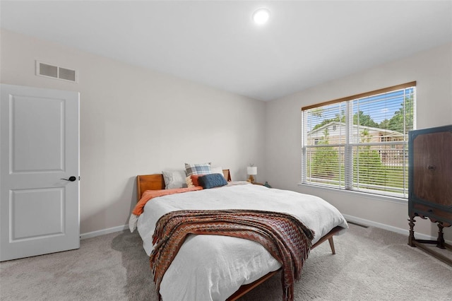 bedroom with light colored carpet