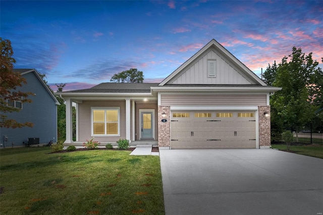 view of front of property with a garage and a yard