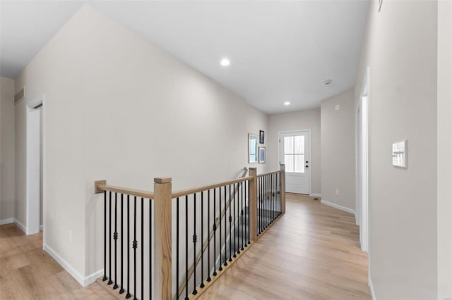 hall with light hardwood / wood-style floors