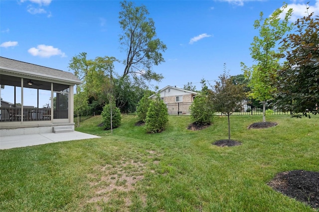 view of yard featuring a patio and a sunroom