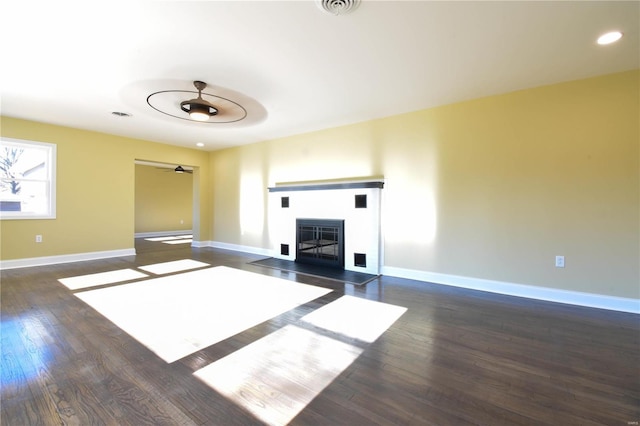 unfurnished living room with ceiling fan and dark hardwood / wood-style floors