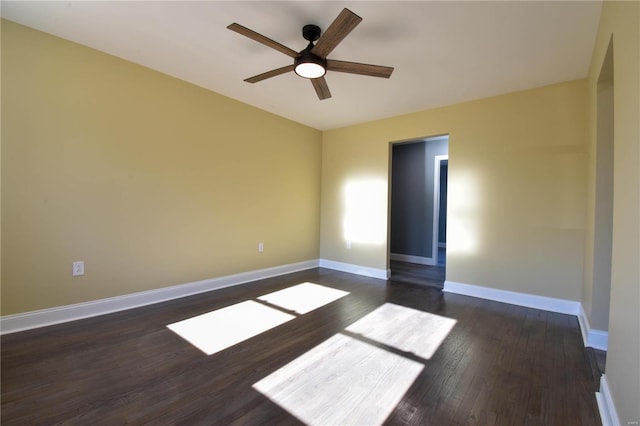 empty room featuring dark hardwood / wood-style flooring and ceiling fan