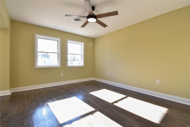 spare room featuring dark hardwood / wood-style floors and ceiling fan