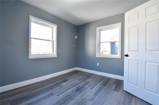 spare room with dark wood-type flooring