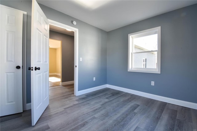 spare room with dark hardwood / wood-style floors