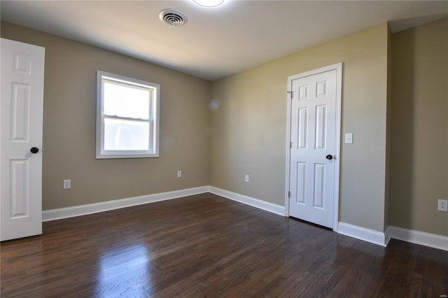 spare room featuring dark wood-type flooring