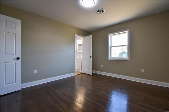 spare room with dark hardwood / wood-style flooring