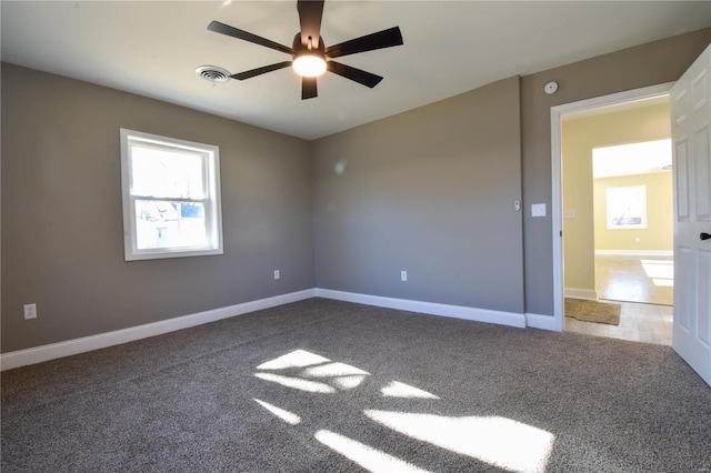 empty room featuring ceiling fan and carpet floors