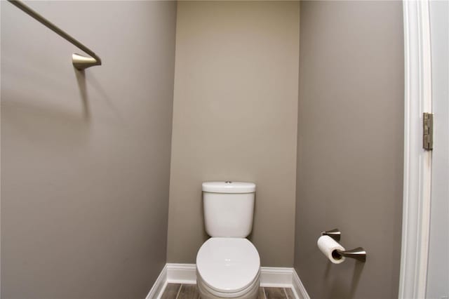 bathroom with hardwood / wood-style flooring and toilet