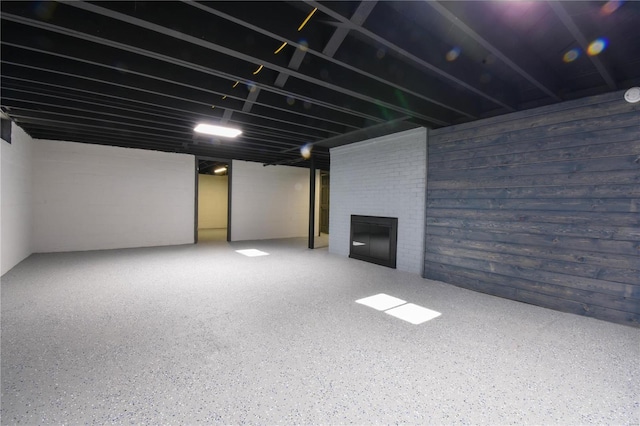 basement featuring a brick fireplace