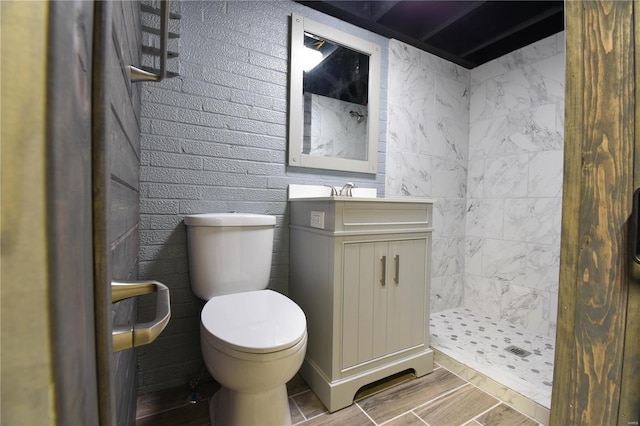 bathroom featuring vanity, toilet, and a shower