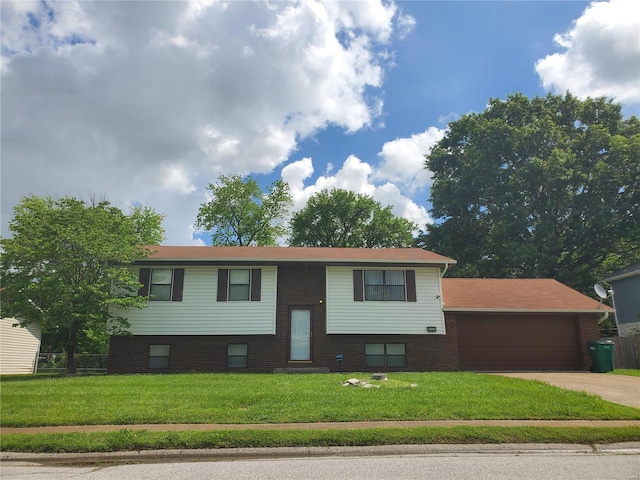 bi-level home with a front yard and a garage