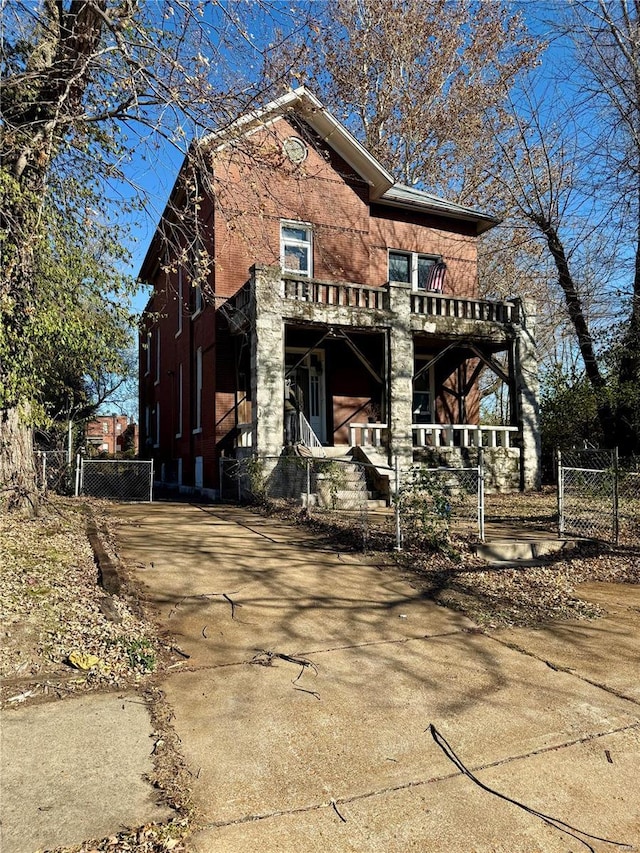 rear view of property featuring covered porch