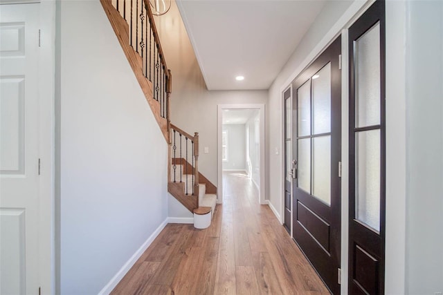 foyer featuring hardwood / wood-style floors and french doors