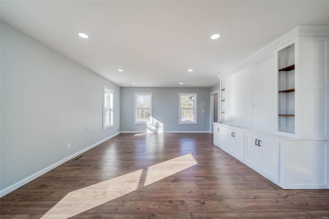 unfurnished living room featuring dark wood-type flooring