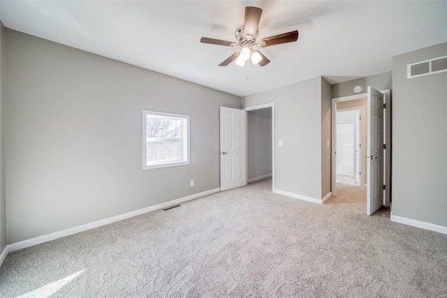 unfurnished bedroom featuring ceiling fan and light colored carpet