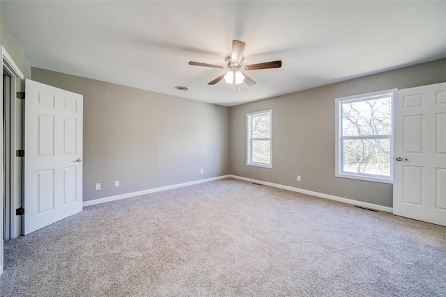 unfurnished room with ceiling fan and carpet floors