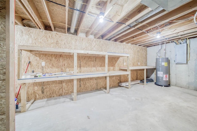 basement featuring electric panel and water heater