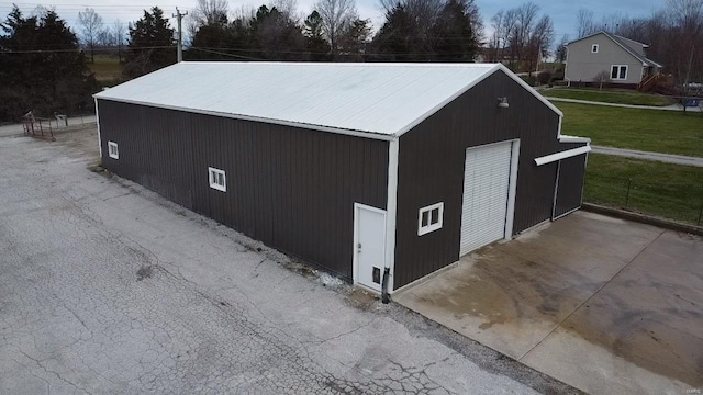 view of outbuilding with a lawn and a garage