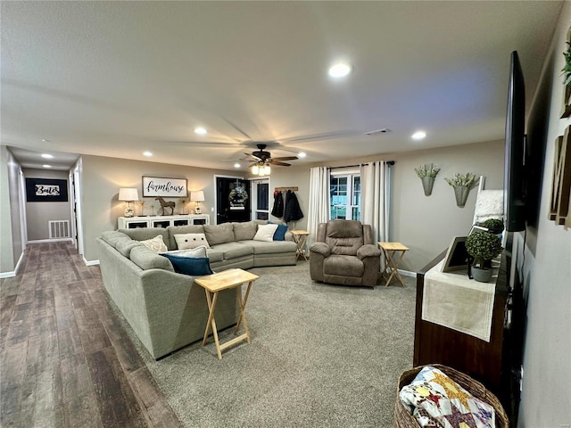 living room featuring hardwood / wood-style floors and ceiling fan