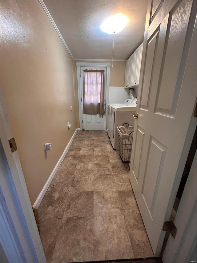 laundry room with ornamental molding, cabinets, a textured ceiling, and independent washer and dryer