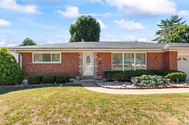 single story home featuring a front yard and a garage