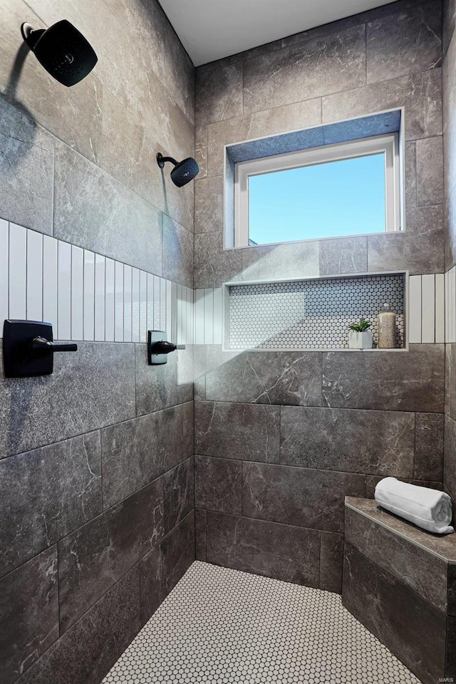 bathroom with a healthy amount of sunlight and a tile shower