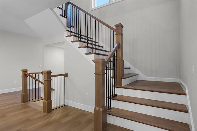 stairs featuring wood-type flooring