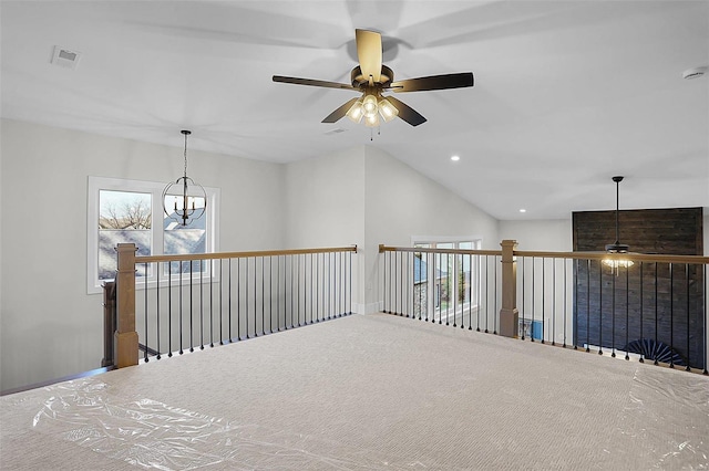 corridor with carpet, a chandelier, and lofted ceiling