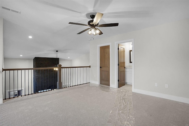 carpeted spare room featuring ceiling fan