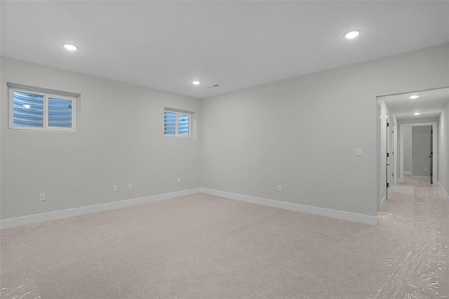 spare room featuring light colored carpet