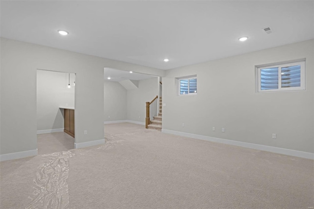 basement featuring light carpet