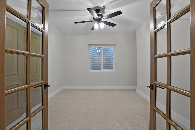 unfurnished room with french doors, light colored carpet, and ceiling fan