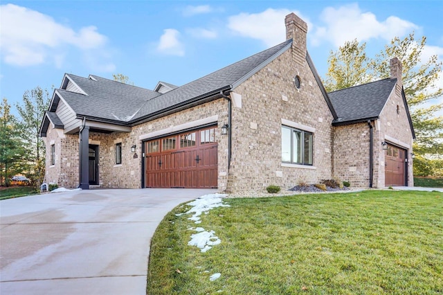 view of front of home with a garage and a front lawn