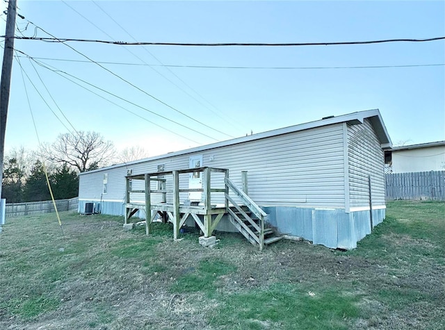 view of outbuilding featuring cooling unit and a lawn