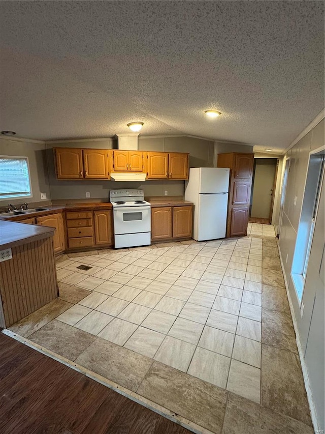 kitchen with light wood-type flooring, white appliances, a textured ceiling, and ornamental molding